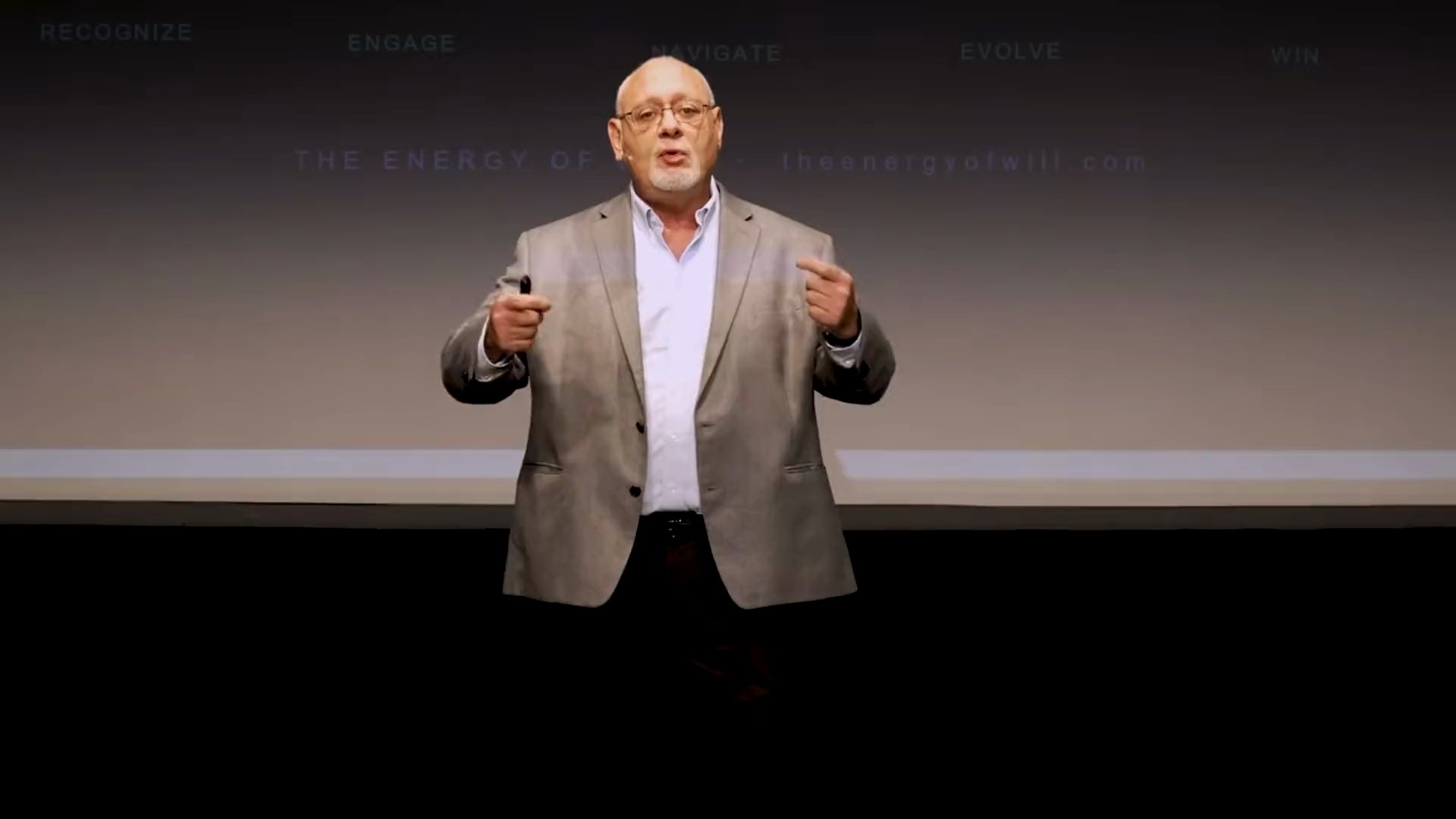 Bill Schuhlein speaking on stage